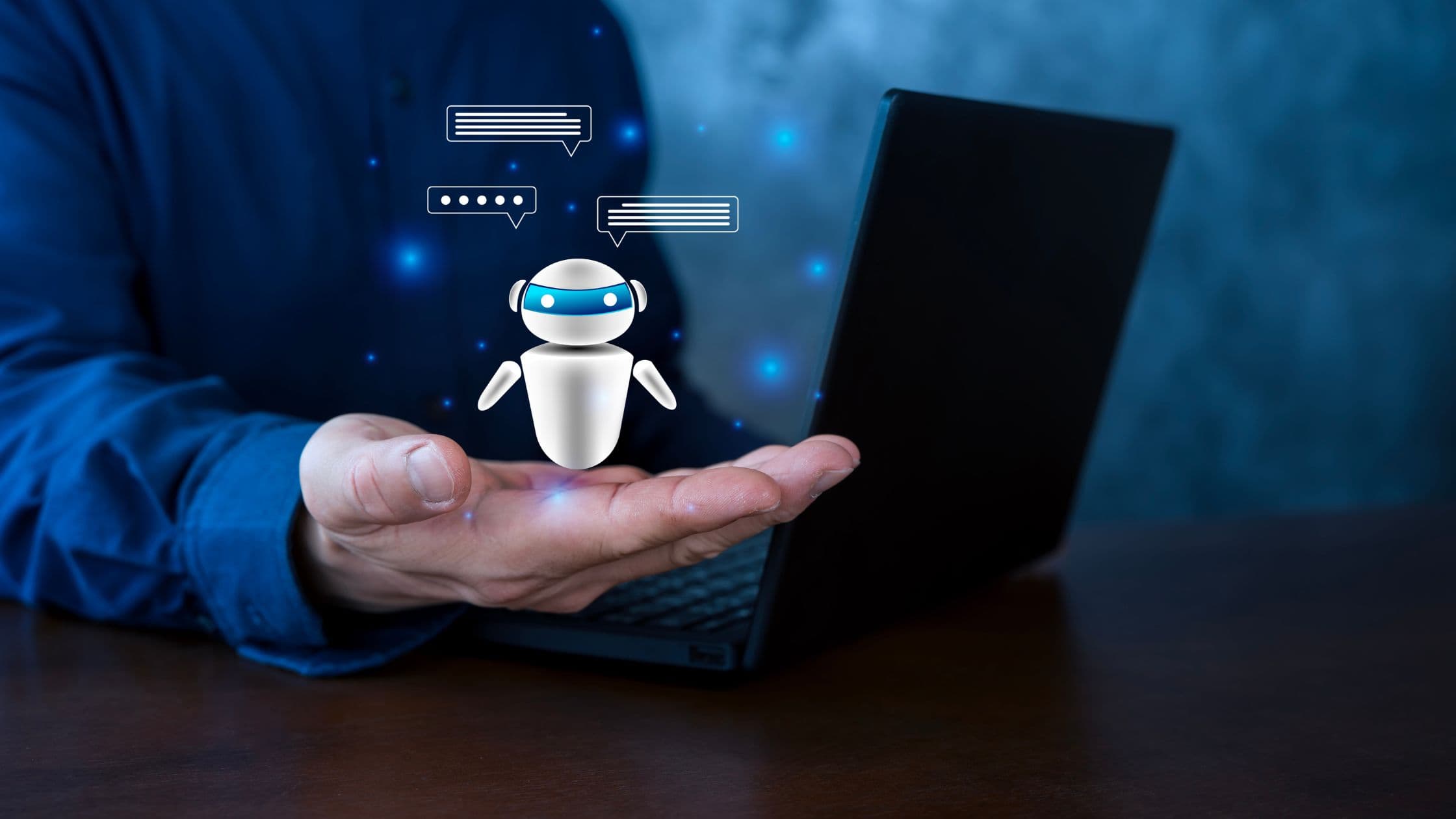A small AI robot hovering above a laptop, representing an AI voice agent plugged into a GoHighLevel workflow as an automated calling step